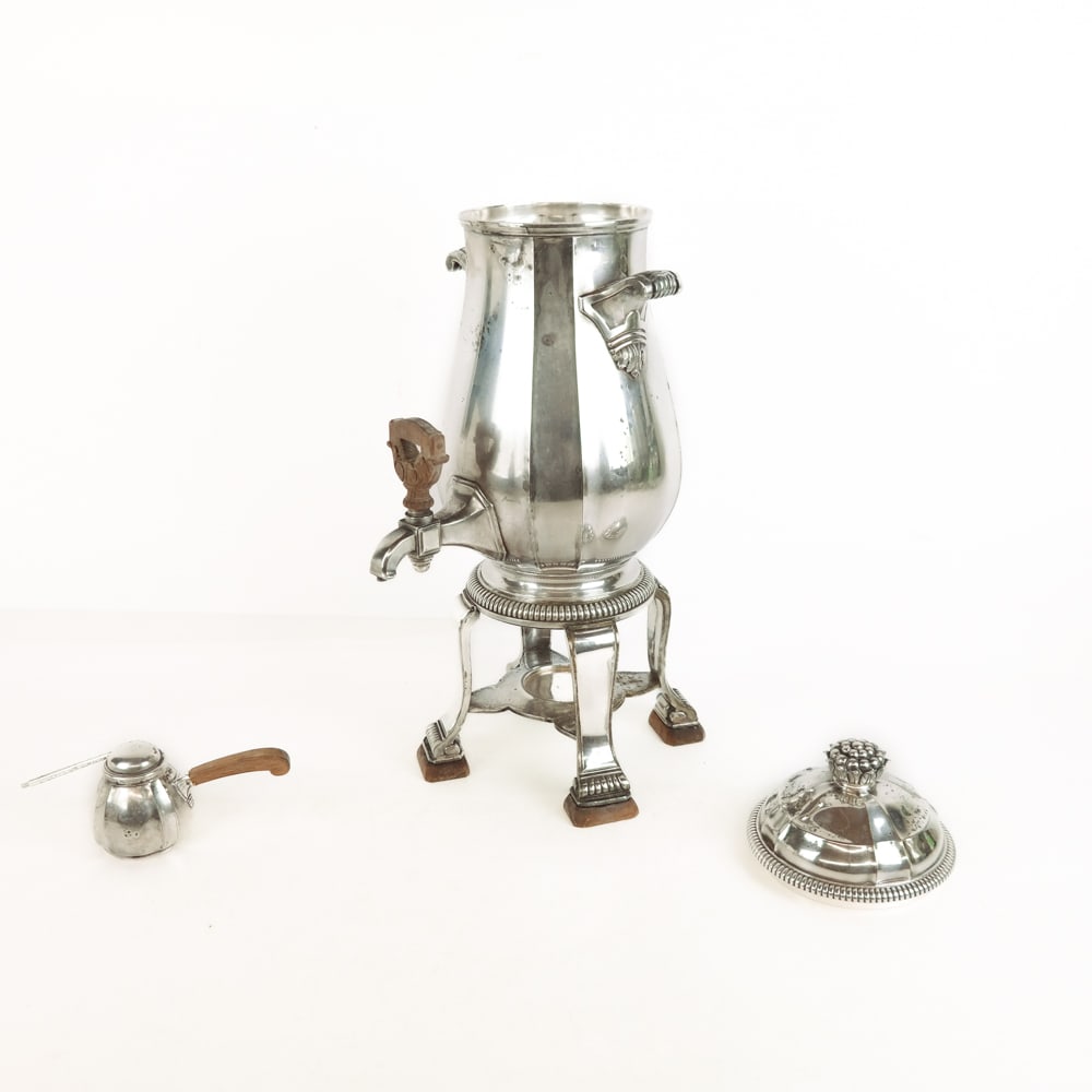 French Silver Plate Hot Water Urn: French silver plate hot water urn, Paris, raised on scroll feet affixed with wood blocks, marks to bases, heating element. [16" H x 6" W x 8" D]. Overall condition is good, tarnished and wear with som