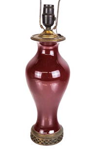 Chinese Oxblood Vase Mounted as a Lamp: Chinese sang de beouf oxblood vase, 20th century, mounted as a lamp on a gilt stand. [To lip: 14" H x 6" Diameter]. Condition is good, stand and lid not removed; wires cut.