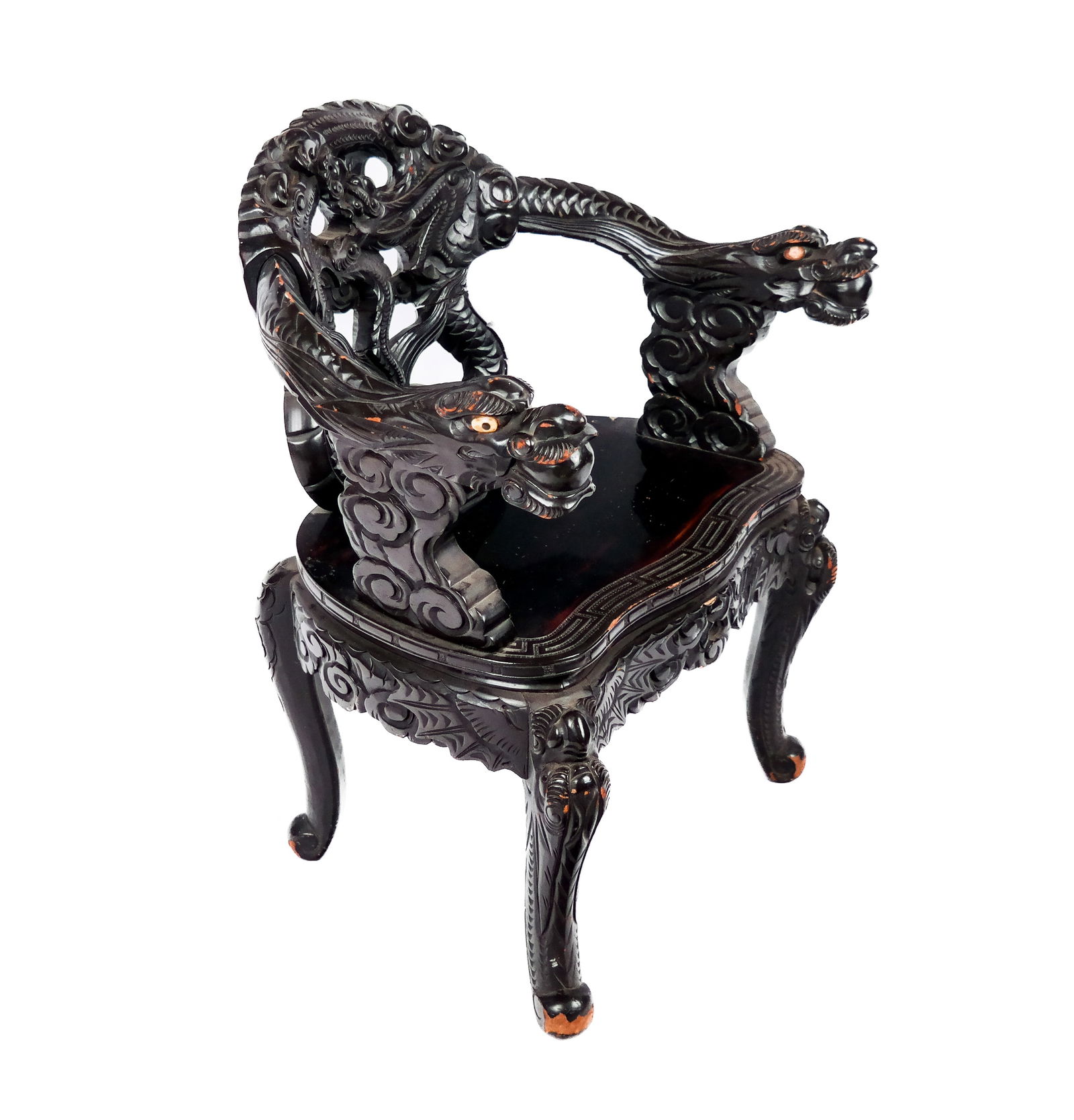 Japanese Export Carved and Lacquered Armchair: Japanese export carved and lacquered armchair, early 20th century, with a heavily carved dragon design to back rest, and two dragon form arms with inset bone eyes, thunder pattern to seat, and four ca