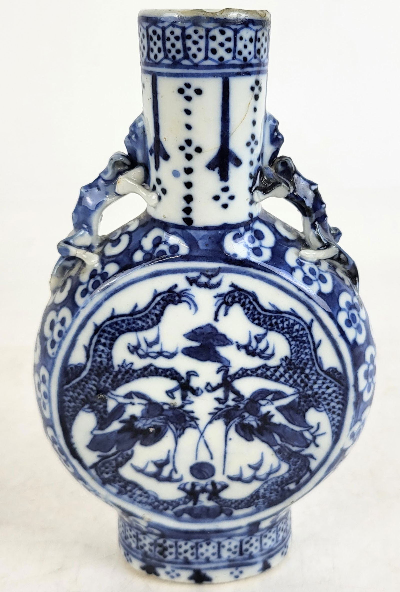 Chinese Qinghua Decorated Baoyueping Moon Flask: Chinese Qinghua blue and white decorated baoyueping moon flask, possibly Qing Dynasty, with a decorated neck, two figural handles, and a central cartouche with flanking dragons, unmarked. [7" H x 4.5"