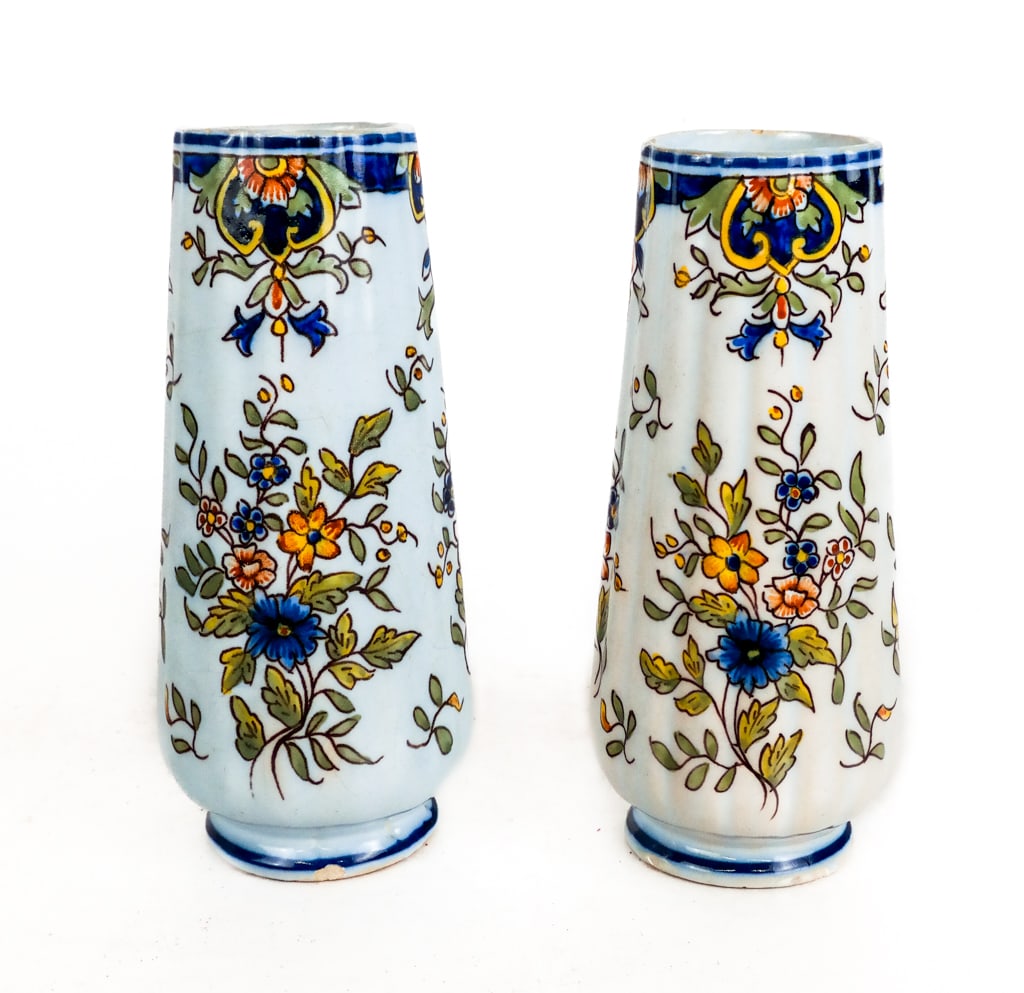 Pair of Rouen Faience Vases: Pair of Rouen faience vases, with reticulated bodies, and hand-painted foliate decoration, marked Rouen to base of each. [8" H x 4" Diameter]. Condition is good with a chip to lip and repairs to base