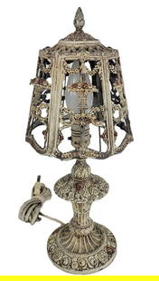 Victorian Cast Iron Boudoir Lamp: Victorian cast iron boudoir lamp, early 20th century, with pierced and painted shade with floral decoration, over a basket form base with foliate accents. [18" H x 7" Diameter]. Condition is good to f
