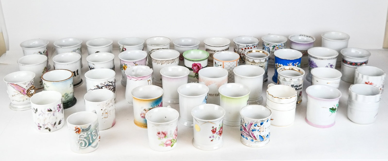 Large Group Porcelain Mugs, 45: Large group of 45 porcelain mugs, various origins including Germany, and Japan. Condition is varied with fading and wear to some. From a New York City Collection.