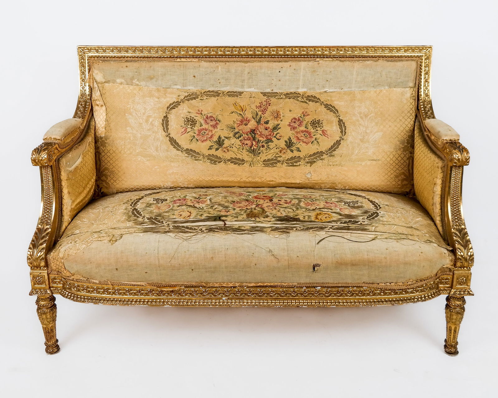 Louis XVI Gilded Canape: Louis XVI couch/sofa, late 19th century, very heavily and elaborately carved, with high backrail and protruding skirt, very nicely gilt. [39" H x 55" W x 29" D]. Needs re-upholstering.