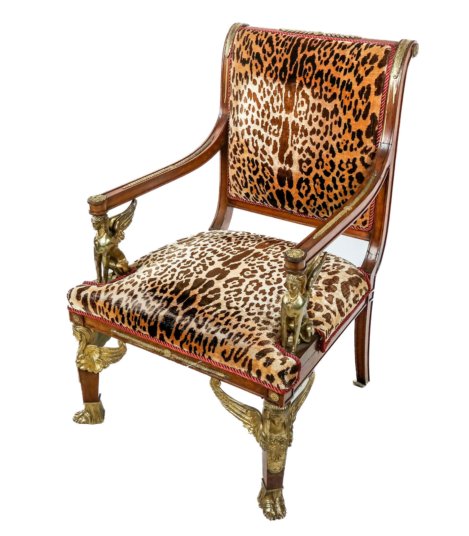 Egyptian Revival Gilt Bronze Mounted Fauteuil: Egyptian Revival gilt bronze mounted fauteuil, the arm supports and feet of sphynx, with wheat and rosette motif accents. [39" H x 25.5" W x 26" D, Height Seat: 16.5"]. Overall condition is good, worn