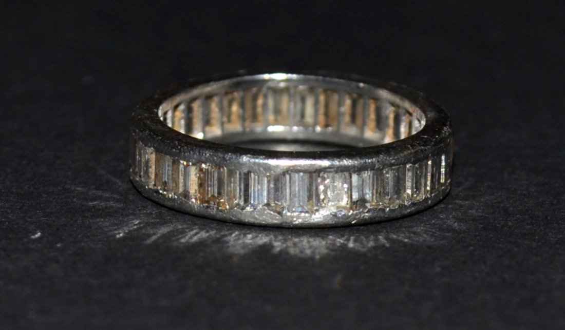 Platinum & Diamond Wedding Band: Platinum, diamond wedding band. 32 Baguette diamonds weigh approximately 3.20ct (total) J-K color; VS-2/Imperfect clarity (2 broken stones) channel set ring measures 5mm wide; finger size 8; and weigh
