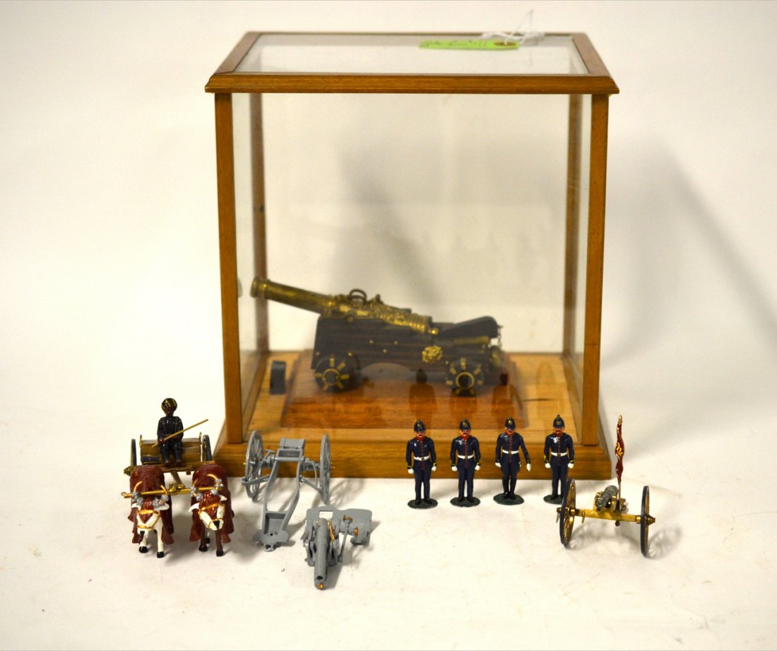 Contemporary Miniature Artillery Lot: Comprises: 1.) 19th C. / Prussian 4 soldier unit with cannon and oxen cart with driver, 2.) WWI era cannon, 3.) Mounted and cased 18th C. cannon. Condition varies, sold as is.