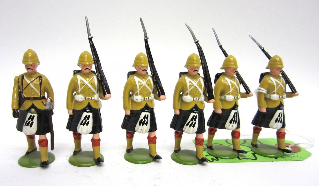 Set of Six Edwardian Highland Colonial Soldiers: Comprises five riflemen with affixed bayonets and an officer with baton. All hand-painted and bear pith helmets and kilts. [Riflemen: 2 7/8" H]