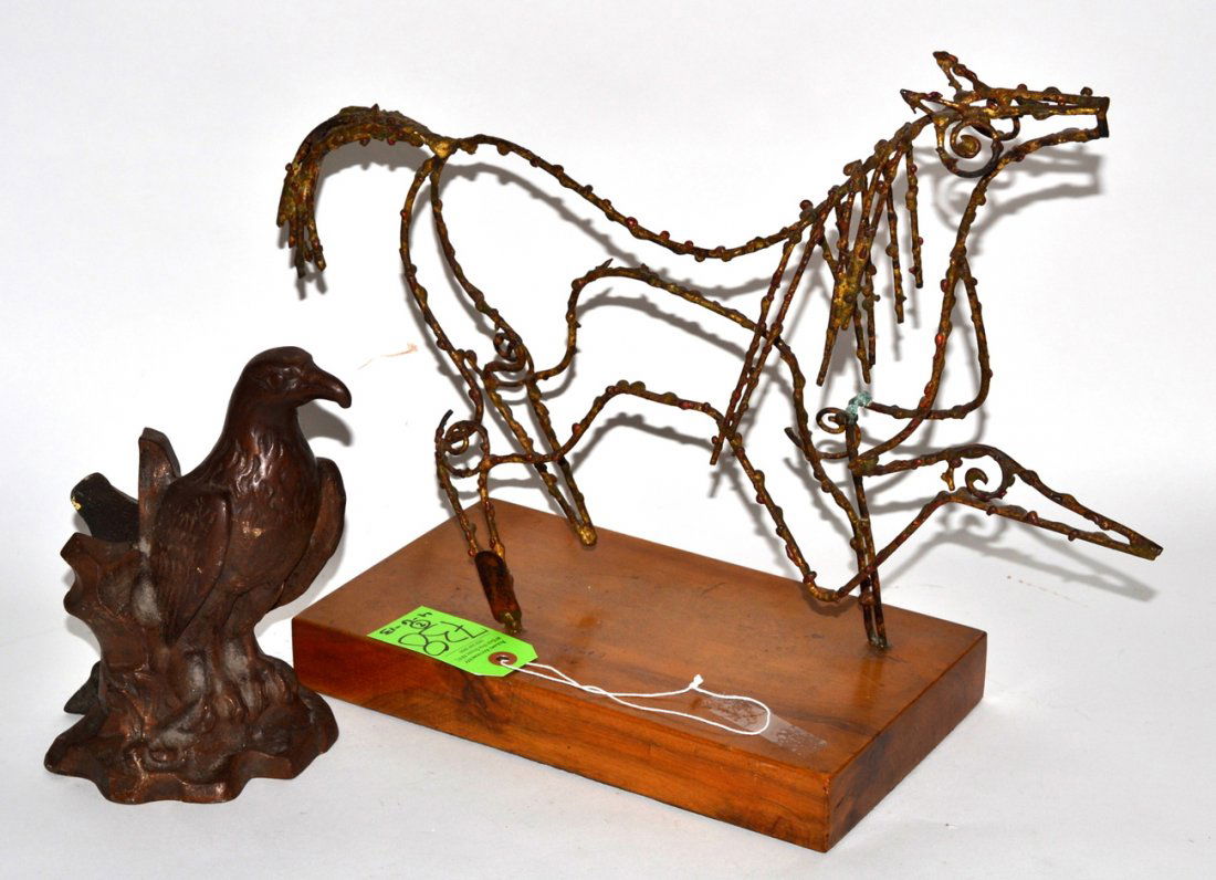 Two Animal Sculptures: Comprises: 1) Modern abstract welded steel linear horse sculpture on wood base. Signed illegibly on rear leg. Overall: 18 1/2"W x 7"D x 14 3/8"H. 2) Antique cast iron eagle door stop. Marked on bottom