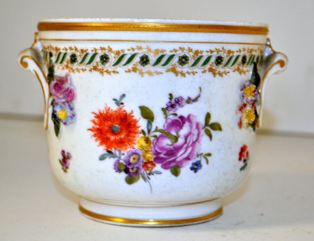 Antique Carl Thieme Porcelain Cache Pot: Cache pot with hand painted applied floral decor, gilt accents, and scrolling acanthus leaf hands. Marked on bottom. 5 1/2"W x 4 5/8"D x 3 7/8"H. Minor chips and wear on top edge.