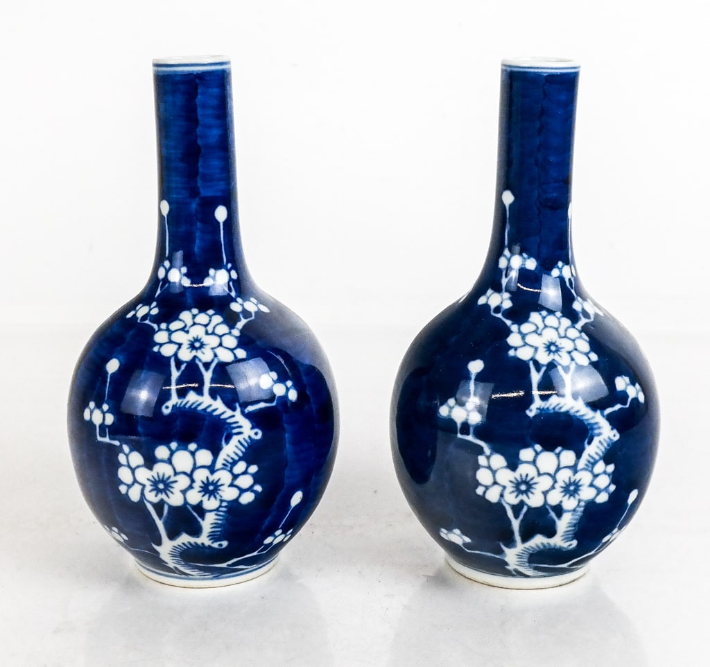 Chinese Near Pair Bud Vases: Chinese near pair blue and white bud vases, 20th century, with cherry blossom decoration, both unmarked. [8" H x 4.5" Diameter]. Condition to each is good.