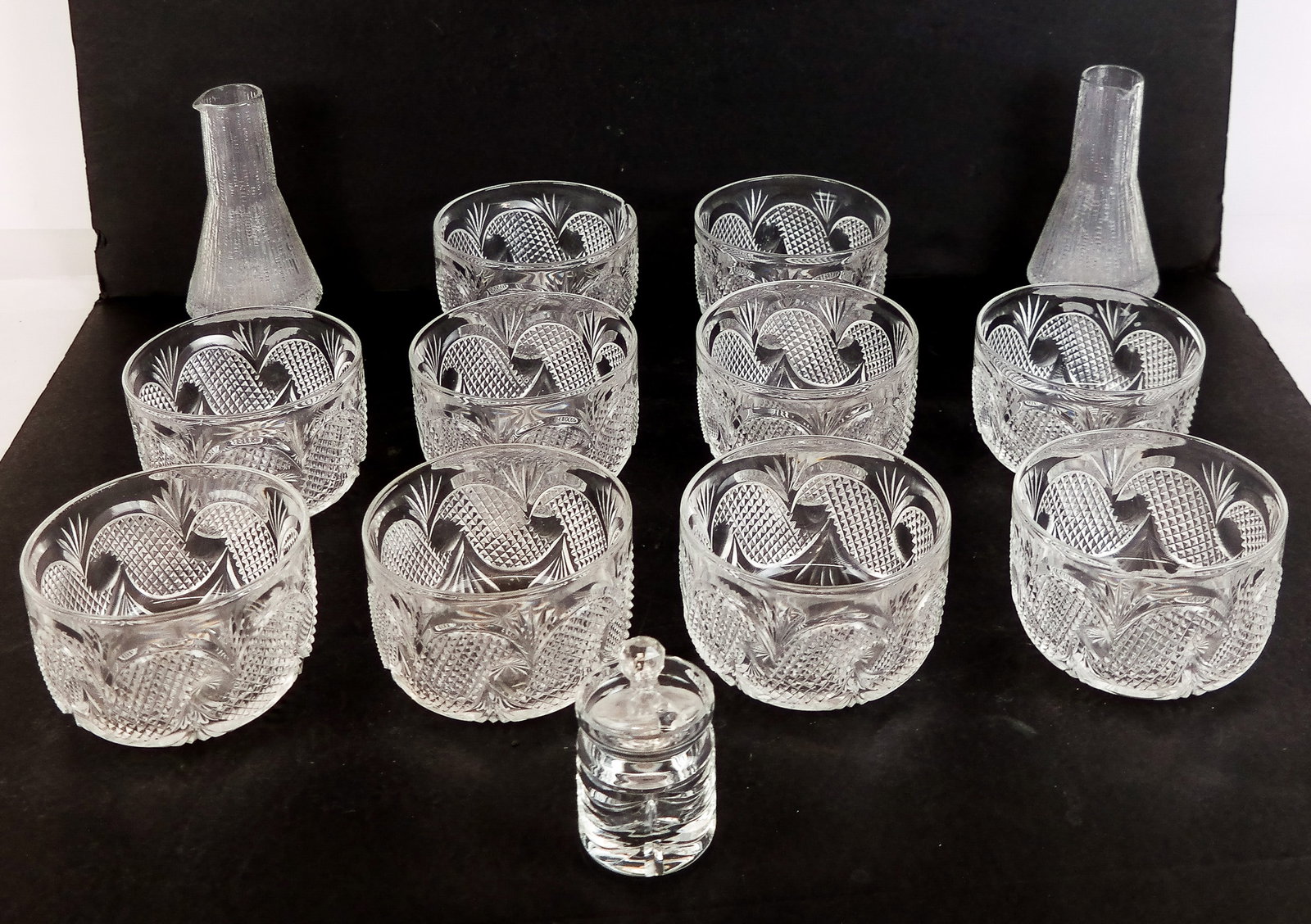 Glass & Crystal Items, 13: Group of 13 glass and crystal items, including ten cut crystal bowls, a pair of glass vases and a covered jar. [Largest: 6" H; 3" H x 4.5" Diameter].