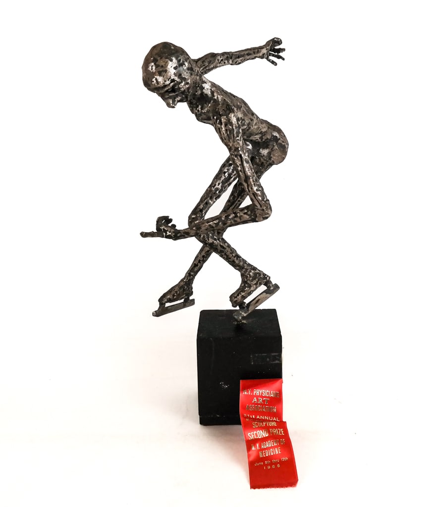 Edward GOLDSTEIN Brutalist Figure of Skater: Edward Goldstwein (American) Brutalist welded metal figure of a skater, mounted on a wood block, circa 1986, with afixed paper label and second prize award from the NY Physicians Art Association. [18.