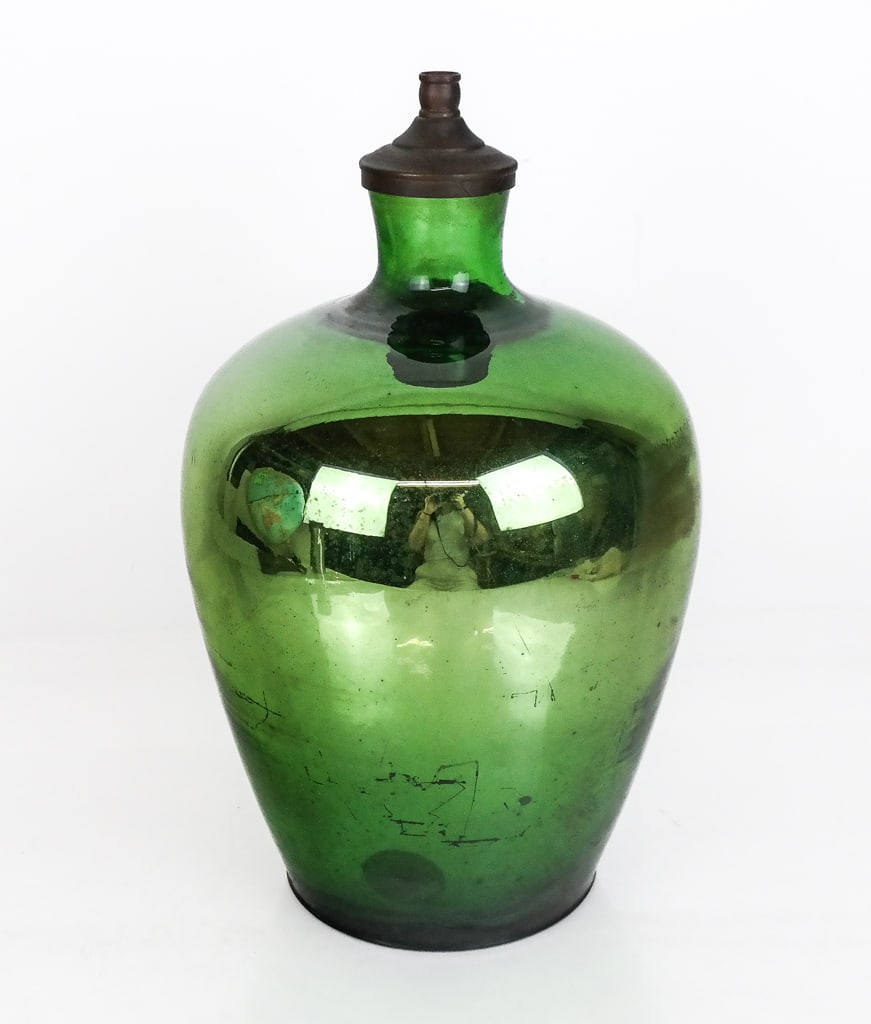 Mercury Glass Jar: Mercury glass jar, late 19th to early 20th century, with an affixed lip to top, possibly where previously mounted as a lamp. [14" H x 8" Diameter]. Condition is good with some wear to glass and losses