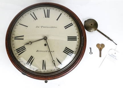 Ringstead Wall Clock: Ringstead wall clock in a round walnut case, 20th century, marked Ringstead and Ja S Phillipo to face, works obscured; keys present. [Excluding pendulum: 15" Diameter x 6.5" D]. Condition is good with