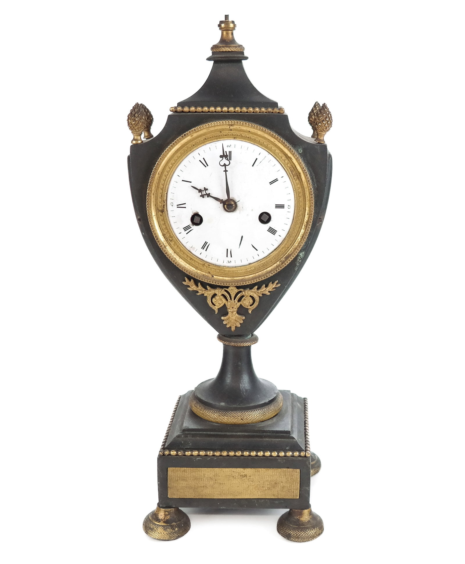 French Patinated Bronze Clock: French patinated bronze clock, 19th century, with an enamel face. [15" H x 6" W x 5" D]. Condition is poor with losses to gilding, damage to works, and losses to finial and face. ROOM 4