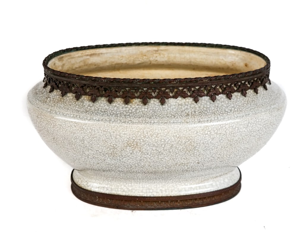 Gilt Metal Mounted Crackle Glaze Jardiniere: Crackle glaze and gilt metal mounted oblong jardiniere, French, 20th century, with a scrolling metal mount to top and a pressed foliate decorated metal to foot, unmarked. [7.75" H x 13" L x 8" D]. Ove