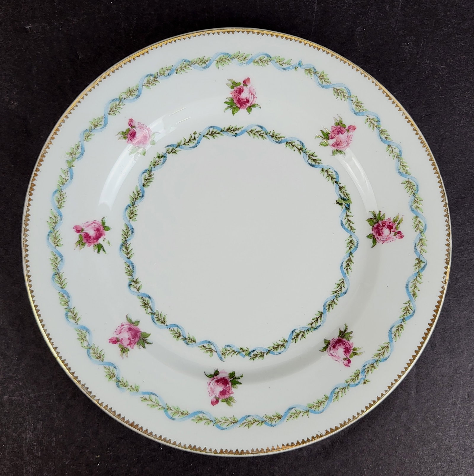 Higgins & Seiter Porcelain Cake Plates, 9: Nine plated retailed by Higgin & Seiter porcelain rose decorated plates with gilt borders, Austria, marks to reverse. [7.75" Diameter]. Overall condition is good, minor wear to gilt.