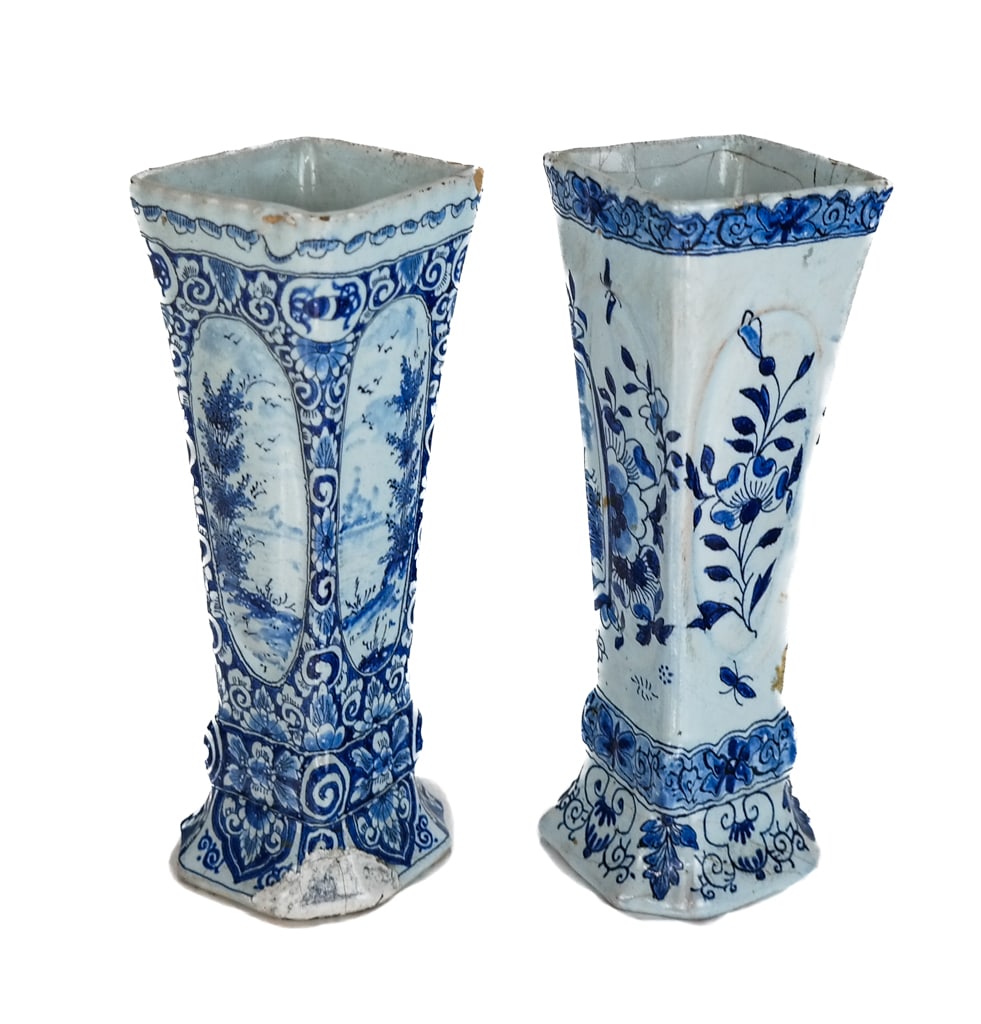 Near Pair of Delftware Vases: Near pair of Delftware vases, 19th century, with blue and white decoration, one marked ARK to base, the other with WK to base. [7" H x 2.5" Square]. Condition to each is good to fair with fading and m