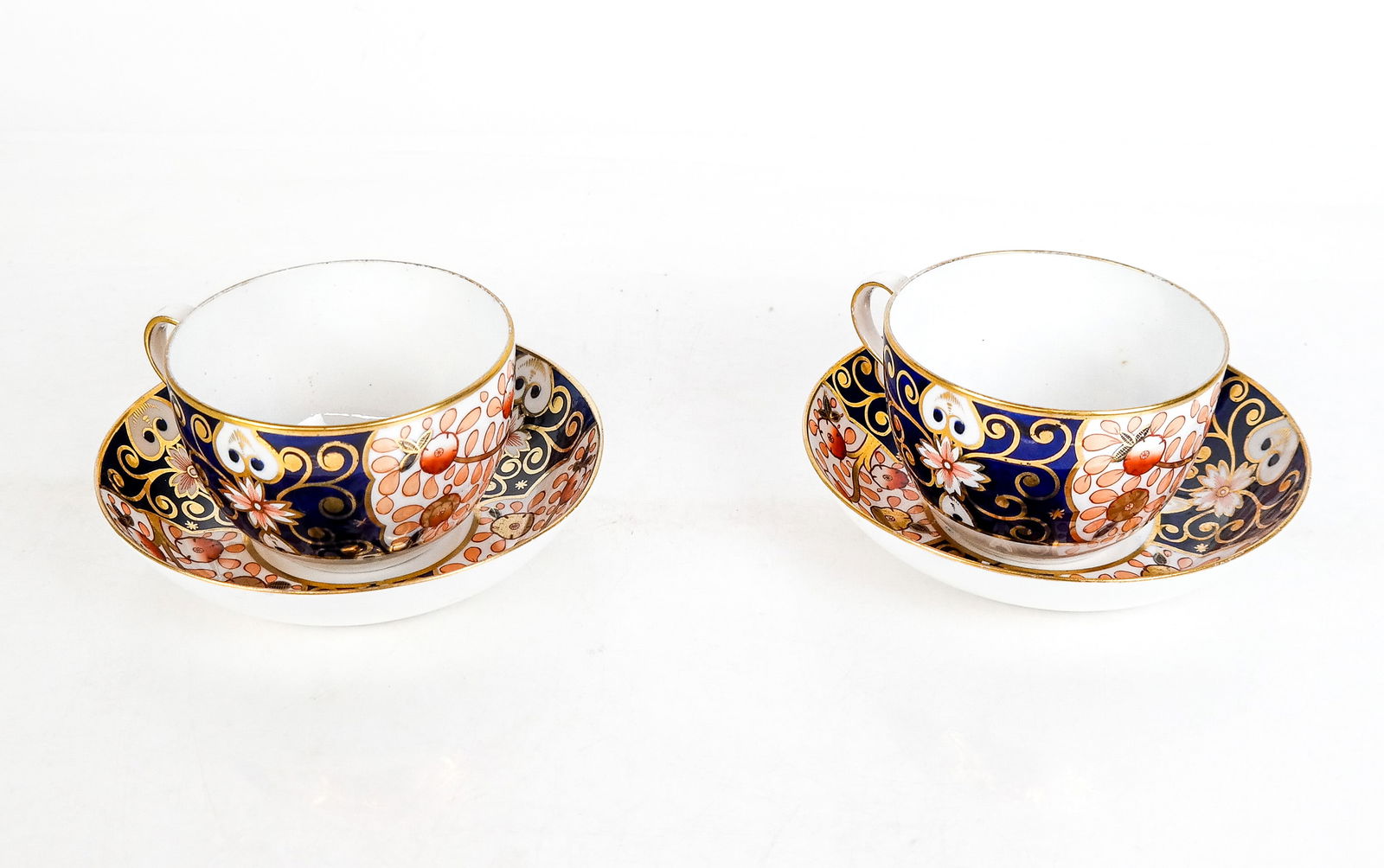 Pair of Spode Teacups and Saucers: Pair of Spode teacups and saucers, with early 19th century marks to bases and gilt and floral decoration. [Teacup: 2.5" H x 5.25" W x 4.25" D]. Condition is good with minor wear to decoration.