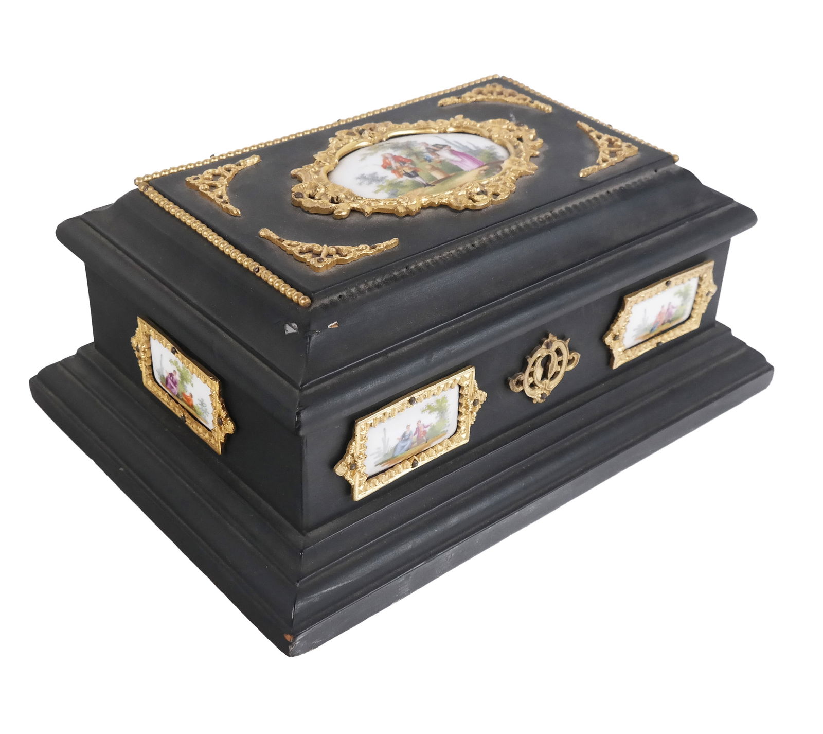 Ebonized Wood Jewelry Box: Ebonized wood jewelry box, 20th century, with gilt metal and porcelain accents and green velvet lined interior. [5" H x 11.25" W x 8" D]. Condition is good to fair with a loss to gilt metal at upper f