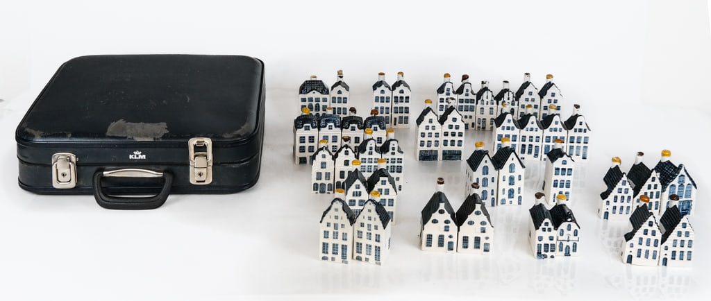 Collection of KLM Delf House Figural Flasks & Suitcase, 41: Collection of KPM Delft house architectural figural flasks, variously designed including model numbers 2, 7, 21, 22, 40-45, 48-51, 53-54, and KPM vintage suitcase, marks to reverse and base. [Suitcase