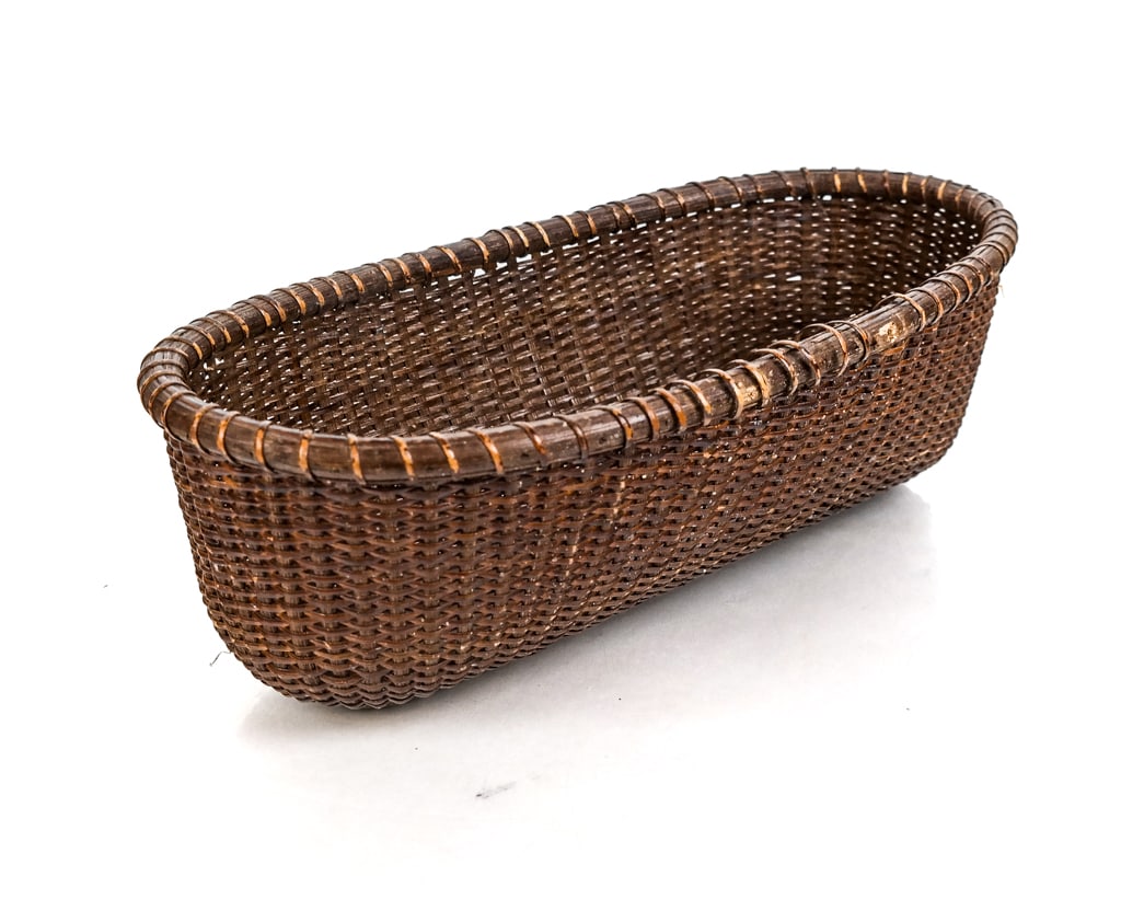 Native American-Style Oval Basket: 20th century oval basket, possibly Native American Indian. [5" H x 14" W x 7.5" D]. Some losses.