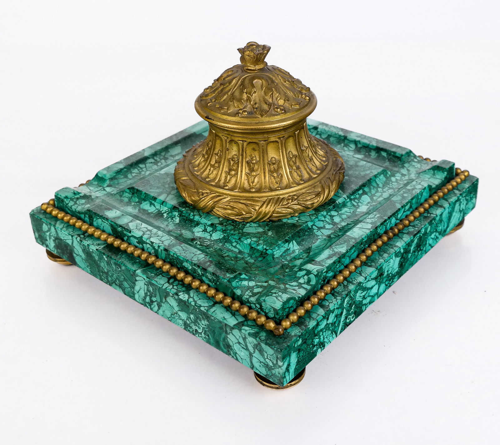 Bronze Dore and Malachite Inkwell: Bronze dore and malachite inkwell, 19th/20th century, with a fruit and foliate decorated inkwell over a malachite base with pen holders and bronze dore cockbeading on feet. [7" H x 8.5" Square]. Condi