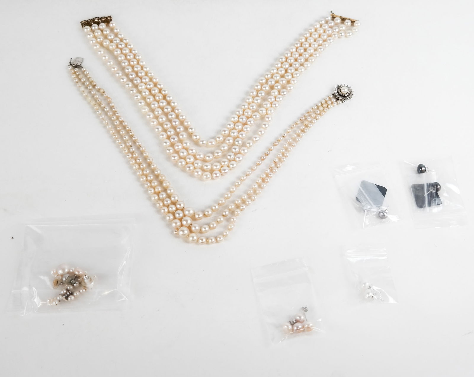 Group of Cultured Pearl Jewelry and Fragments: Group of cultured pear jewelry, comprising four-strand cultured pearl necklace with 14K yellow gold and sapphire bar clasp, pearls approximately 8.5mnm [17" L]; three-strand graduated cultured pearl n
