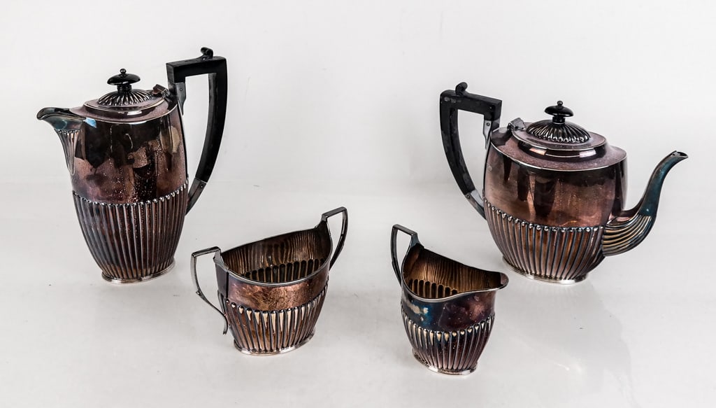 English Silver Tea and Coffee Service, 4: English silver tea and coffee service, Birmingham,1950, by Atkins Brothers, each with fluted lower section, the tea and coffee pots with lacquered handles and finials, comprising teapot, coffee pot, c