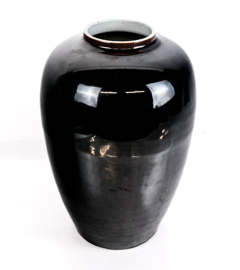 Chinese Black Glazed Porcelain Vase: Chinese black glazed porcelain vase, likely Qing Dynasty, with a white interior, unmarked. [14" H x 9.5" Diameter]. Condition is good.