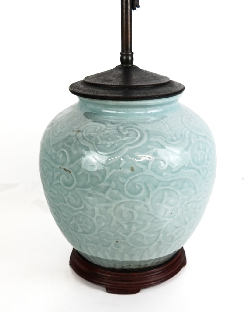 Chinese Celadon Vase Mounted as a Lamp: Chinese celadon vase mounted as a lamp, Qing Dynasty, with impressed foliate and three-clawed dragon decoration, mounted on a later wooden base. [To lip of vase, including stand: 10.25" H x 9.25" Diam