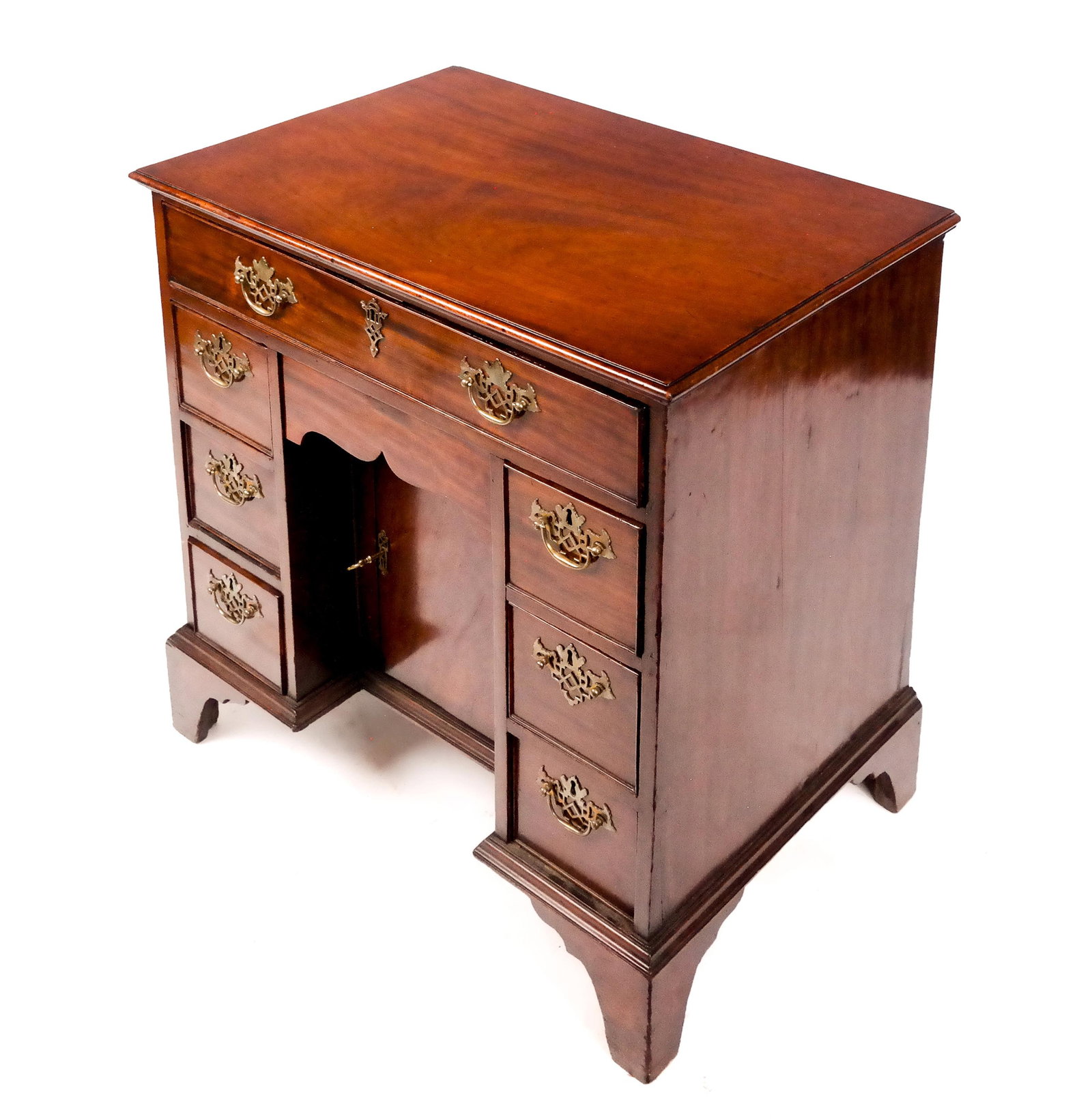English Mahogany Keyhole Desk: English mahogany keyhole desk, 20th century, with brass mounts and one long over three short drawers on each side, flanking a central compartment. [28.5" H x 29" W x 20" D]. Condition is good.