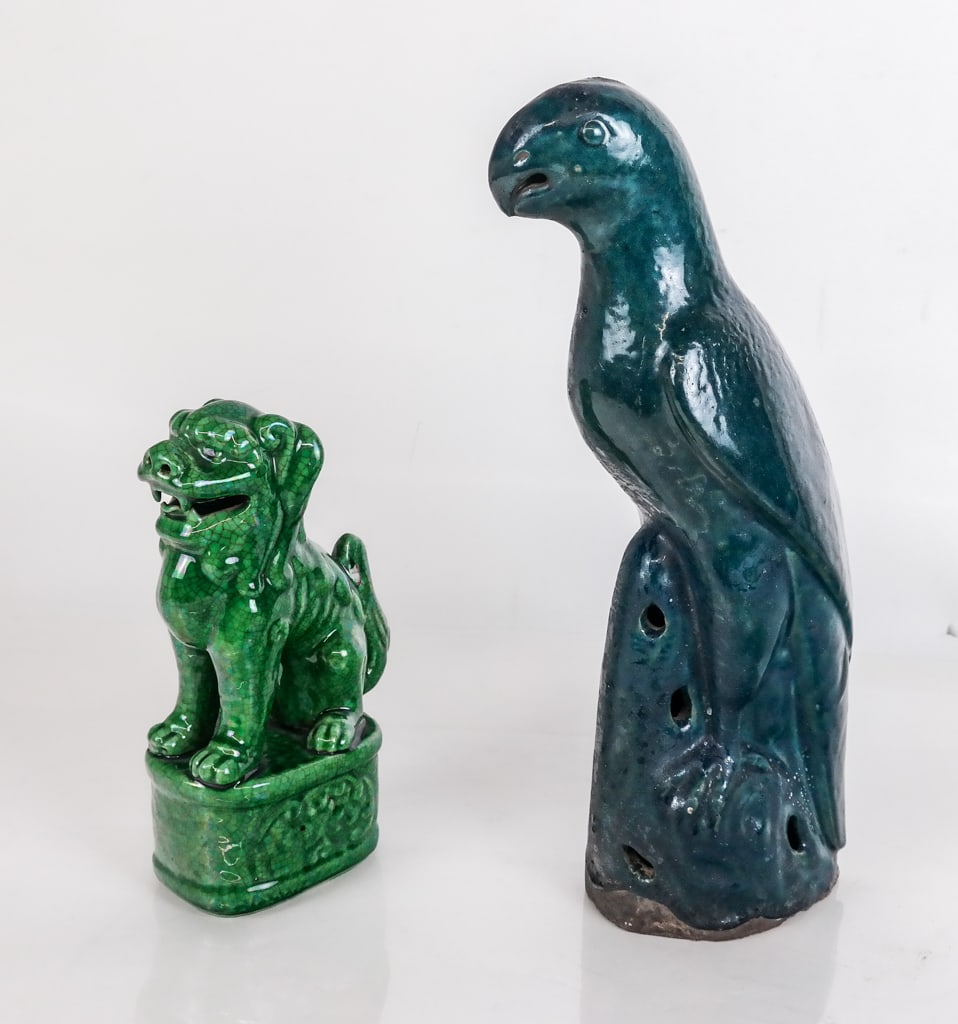 Chinese Turquoise Glazed Parrot and a Foo Dog: Chinese turquoise glazed parrot and a green glazed foo dog, possibly Qing Dynasty, each unmarked. [Parrot: 14" H x 6" W x 4" D]. Condition is good with wear commensurate with age.