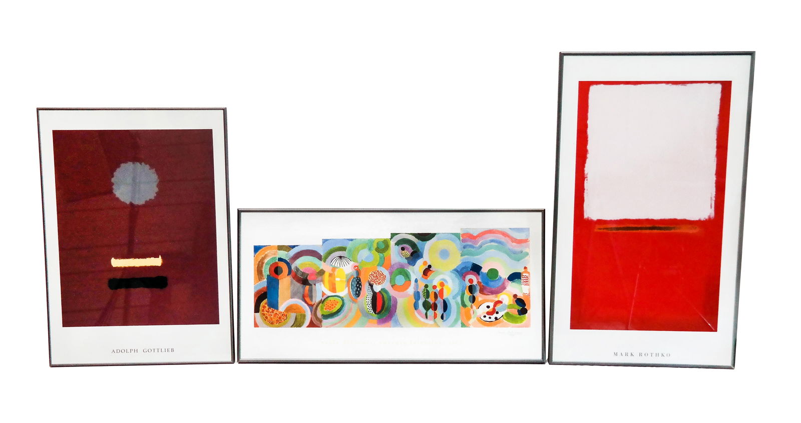 Group of 3 Modern Art Posters: Group of three framed modern art posters, depicting works by Mark Rothko [47.25" H x 28" W], Adolph Gottlieb [39" H x 27.75" W], and Sonia Delaunay 24" H x 47.5" W]. Overall good condition. LOCATED AT