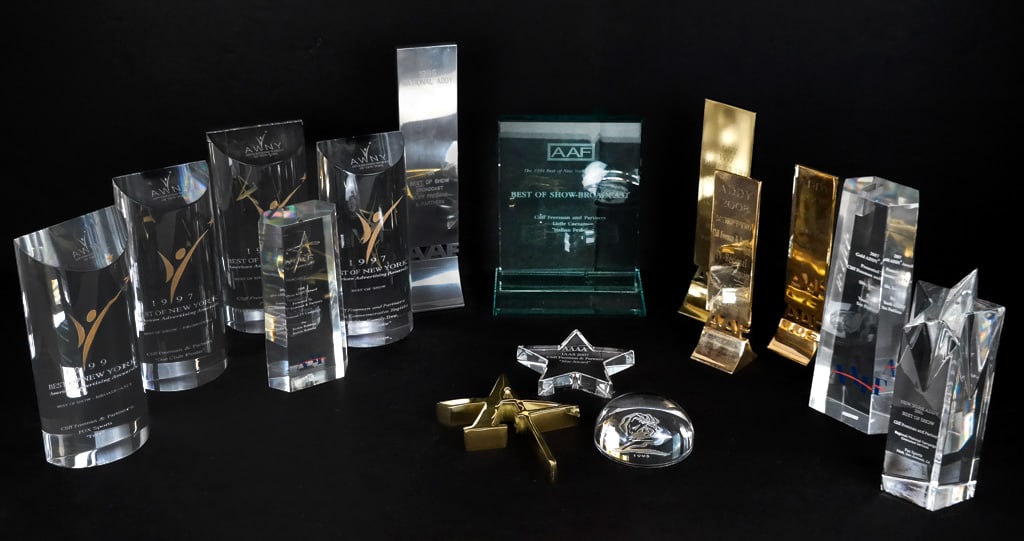 Collection of AAAA & Addy & AWNY & AAF Awards, 15: Collection of awards given to Cliff Freeman and Partners comprising four lucite Best of New York American Advertising awards circa 1995, an glass AAF Best of New York Addy award, a Val Saint Lambert c