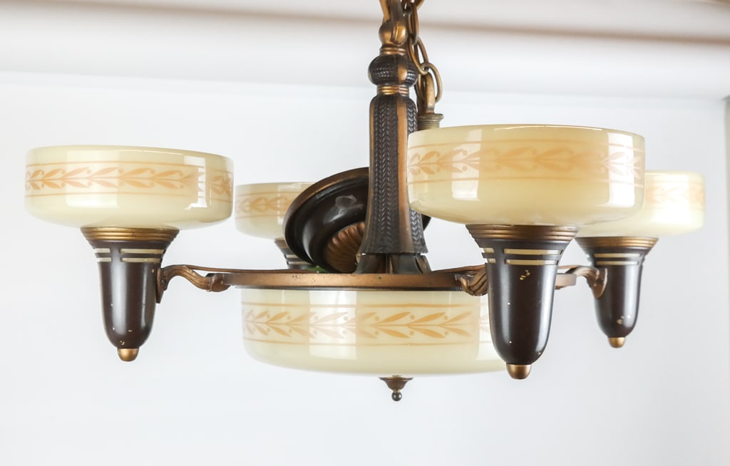 Art Deco Gilt and Milk Glass Chandelier: Art Deco gilt metal and milk glass chandelier, circa 1920, with three lights to interior and a decorated shade, surrounded by four torch lights, accompanied by a receipt from Estelle Sanger Antiques.