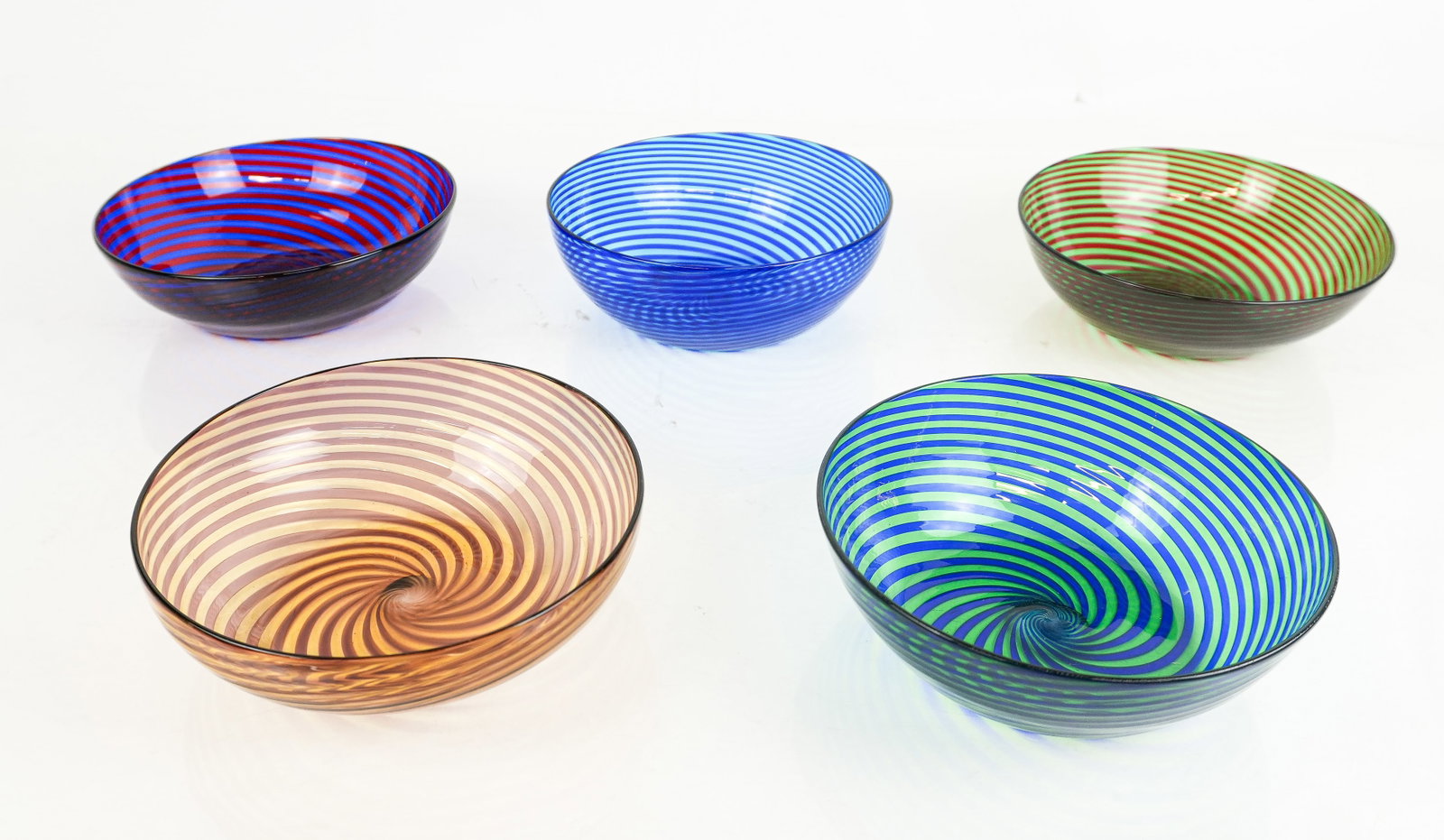 Five Vintage Murano Swirled Glass Bowls: Five vintage murano swirled glass bowls, mid-20th century, in assorted colors, unmarked. [2.25" H x 7" Diameter]. Condition is good.