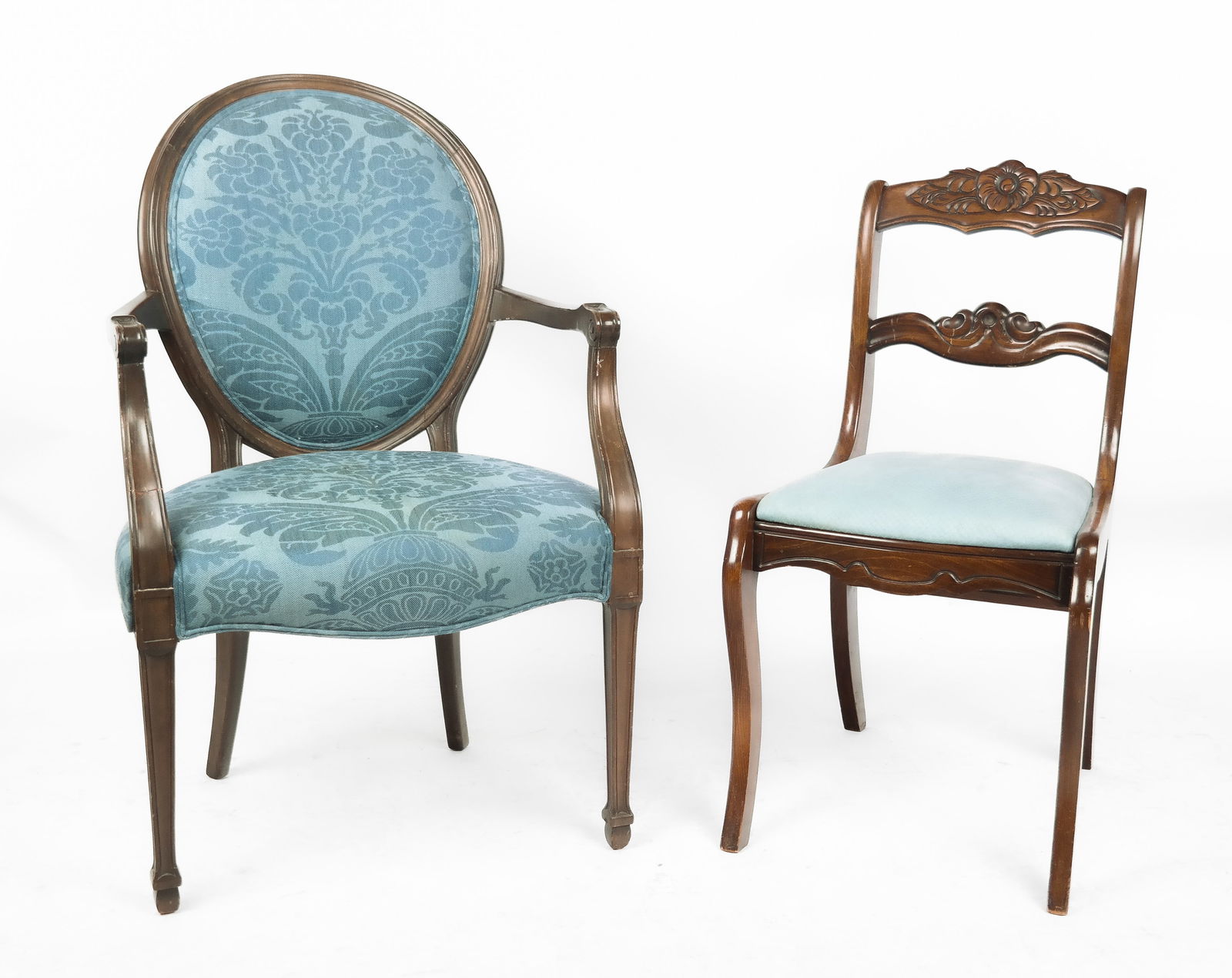 Louis XVI Fauteuil and a Side Chair: Two chairs comprising a Louis XVI fauteuil, 20th century, with carved decoration and blue foliate upholstery, and a side chair with a carved backrest, 20th century, and blue upholstered seat. [Fauteui
