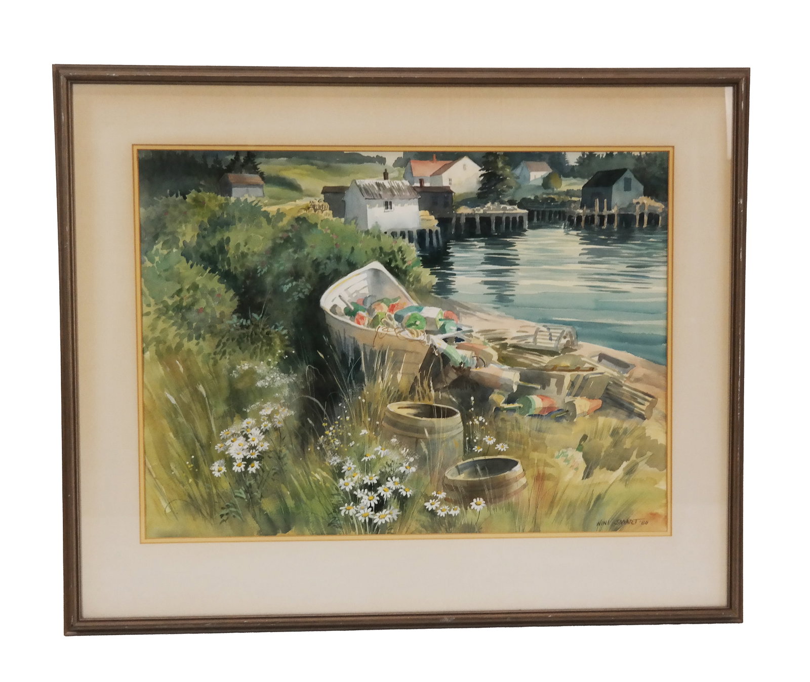 Wini SMART: Village Landscape - Watercolor: Wini Smart (American, 1932-1987) nicely matted and framed watercolor painting depicting a river village landscape with daisies and boats in the foreground and houses in the distance, signed and dated 