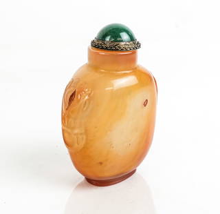 Chinese Carved Agate Snuff Bottle: Chinese carved agate snuff bottle, 19th century, with decorative appliques to each side, married with a green stone and silver tone mounted lid. [3.5" H x 2.25" W x 1.5" D]. Condition is good with som
