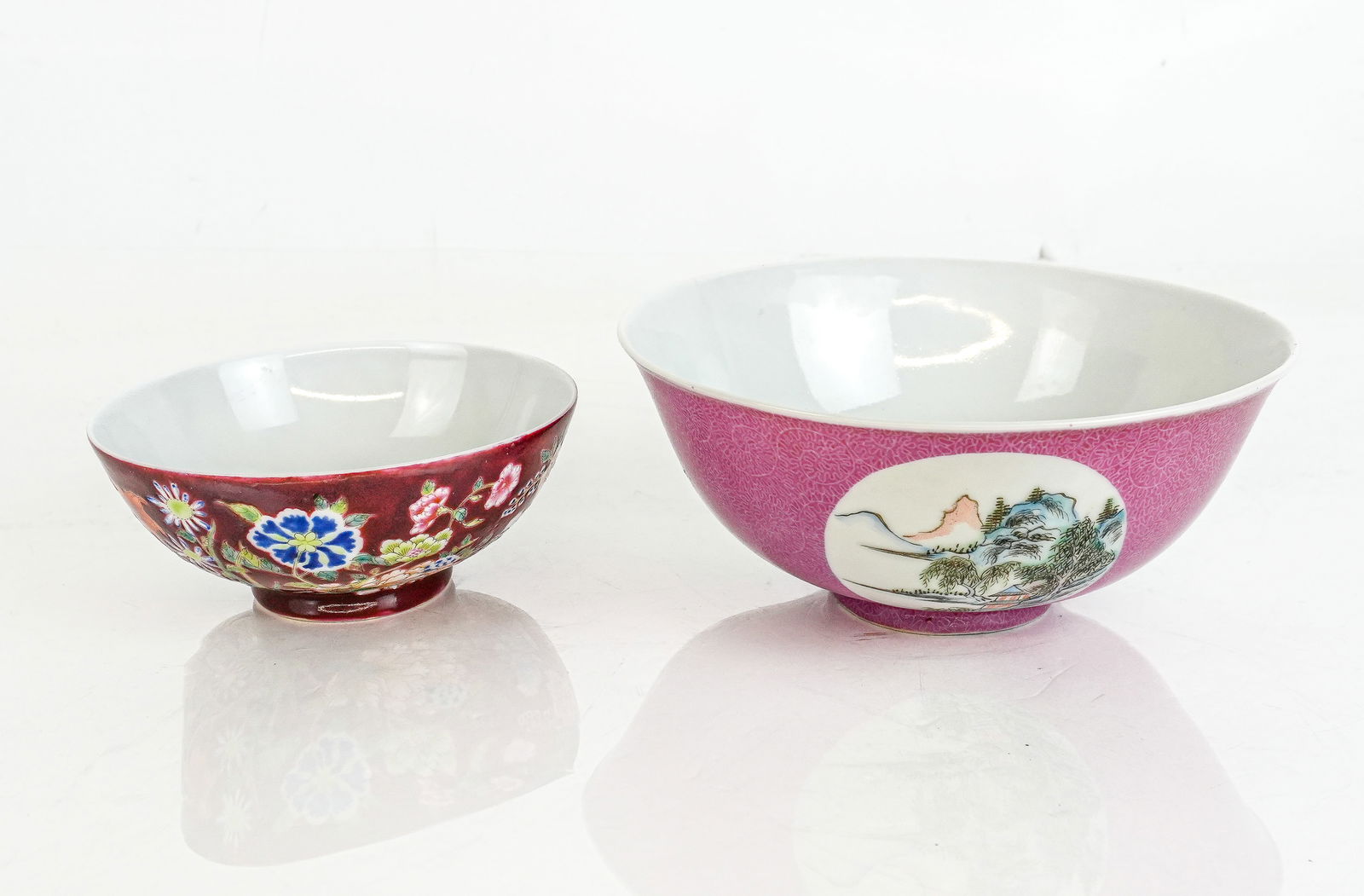 Chinese Two Famille Rose Porcelain Bowls: Two Chinese famille rose porcelain bowls, Qing Dynasty, late 19th century, comprising a floral decorated bowl with marks to base and a ruby bowl with landscape cartouches, marked to base. [Larger: 3"