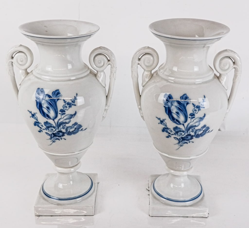 Pair of Meissen Porcelain Floral Decorated Urns: Pair of Meissen porcelain floral decorated urns, German 19th/ early 20th century, with blue and white foliate decoration and two handles to each, on square base, with Meissen thirds marks to base of e