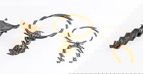 Three Bronze and Brass Door Knockers: Three door knockers, 20th century, comprising a bronze door knocker in the form of a whale tail with affixed strike plate, a Neoclassical brass hand and ring form door knocker, and a Western Americana