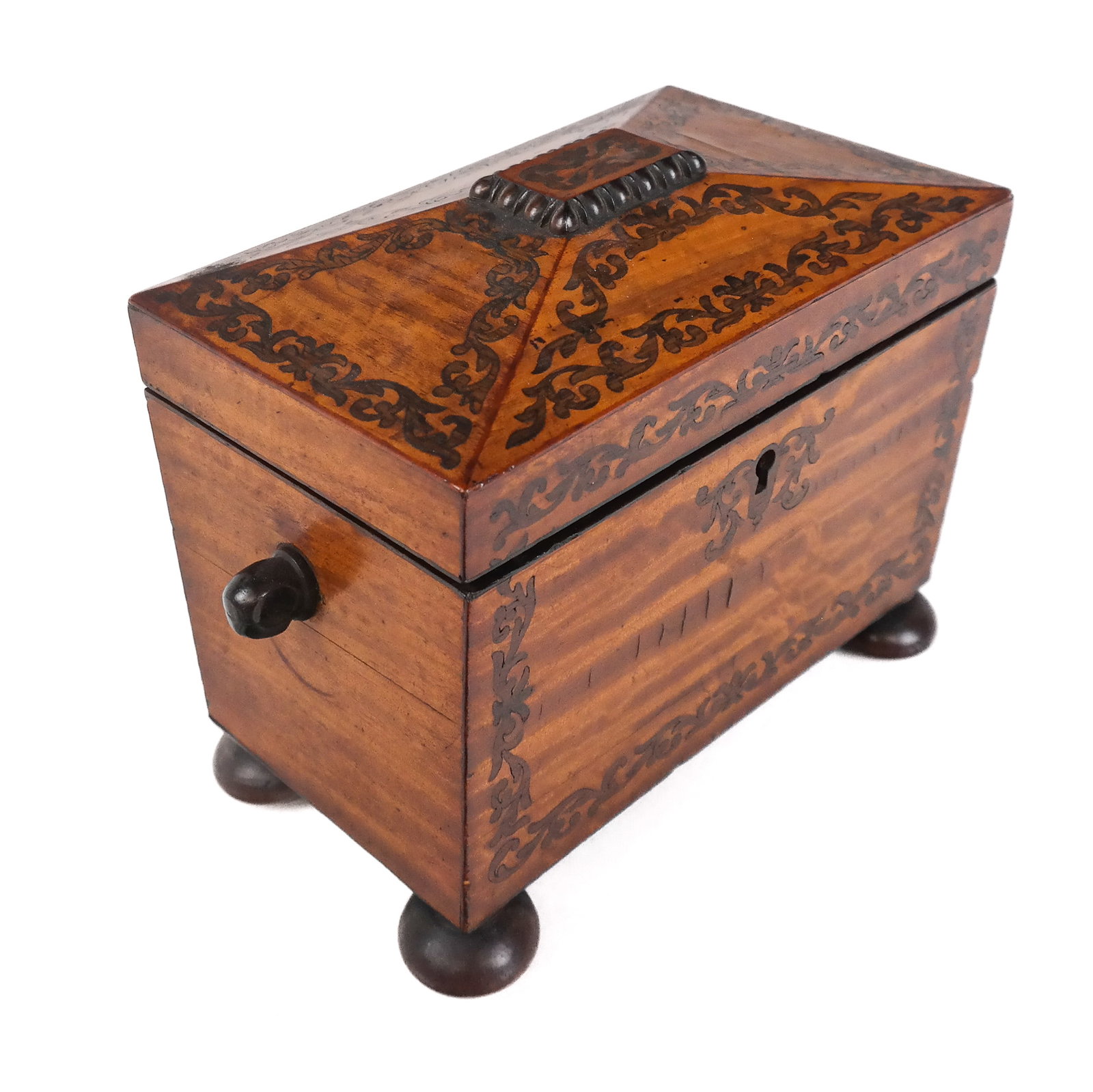 Inlaid Mahogany Sarcophagus form Double Tea Caddy: Inlaid mahogany sarcophagus form double tea caddy, English, 19th century, with scrolled decoration, two handles, a coffered lid opening to reveal two compartments at inner, and bun feet. [7" H x 9" W 