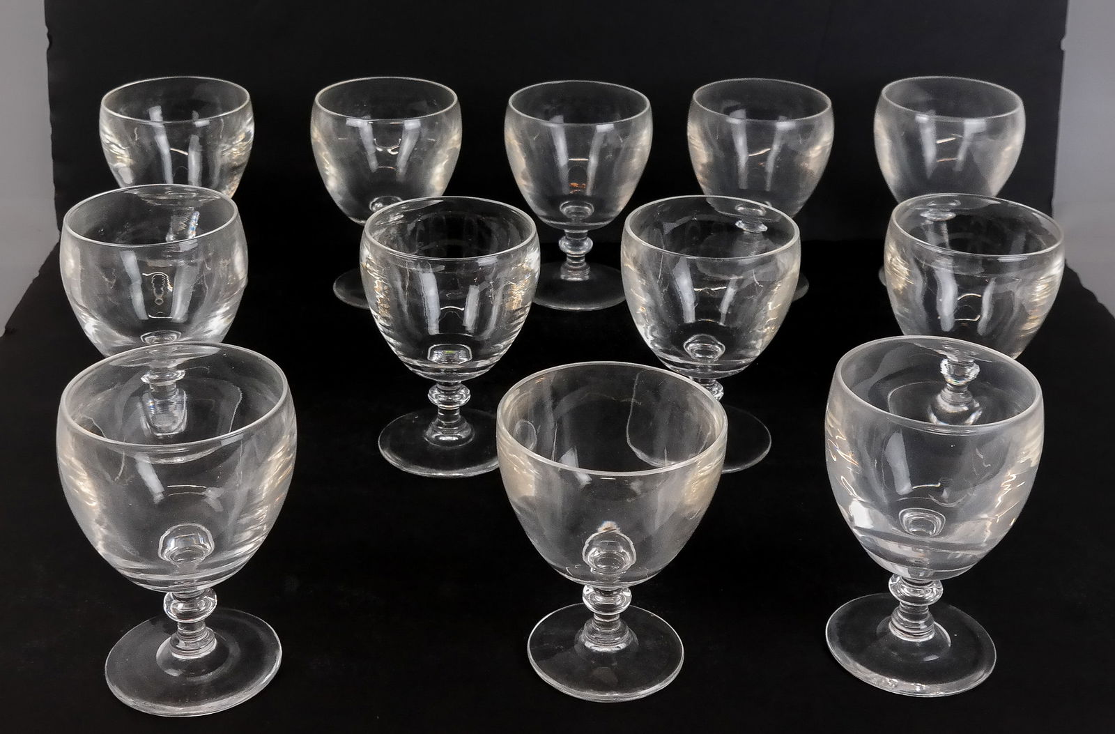 Steuben Crystal Wine Goblets, 12: 12 Steuben crystal wine goblets in original box, all with marks to bases. [5" H x 4" Diameter] Condition is good; sizes vary slightly.