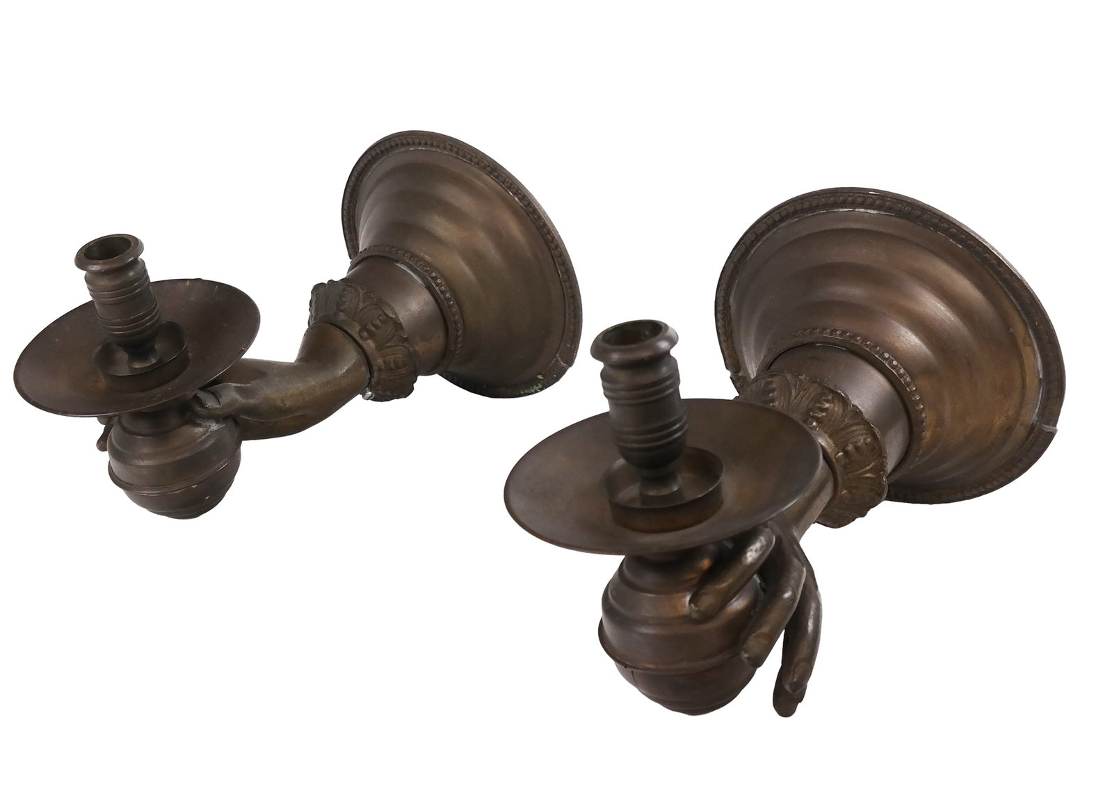 Pair of Whimsical Metal Figural Hand Sconces: Pair of whimsical metal figural hand sconces, designed as a hand extended through a sleeve, and holding a sphere surmounted by a bobeche. [6.5" H x 9.5" L x 6.5" D]. Overall condition is good.
