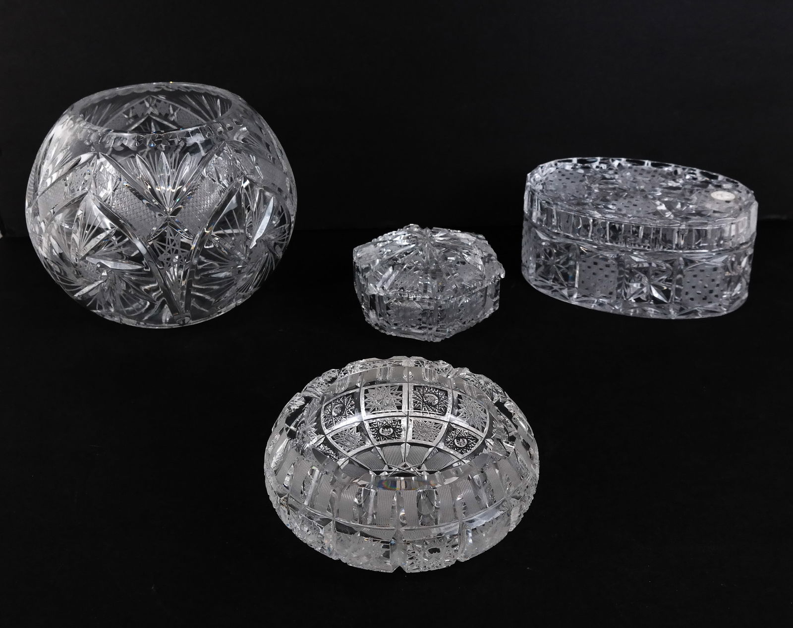 Crystal Clear Et. Al Cut & Molded Glass Articles 4: Collection of 4 cut crystal and molded glass vanity / desk / table accessories, comprising an ashtray [2.25" H x 6" Diameter], a hexagonal lidded vanity / desk box [3" H x 4" Diameter], a Crystal Clea