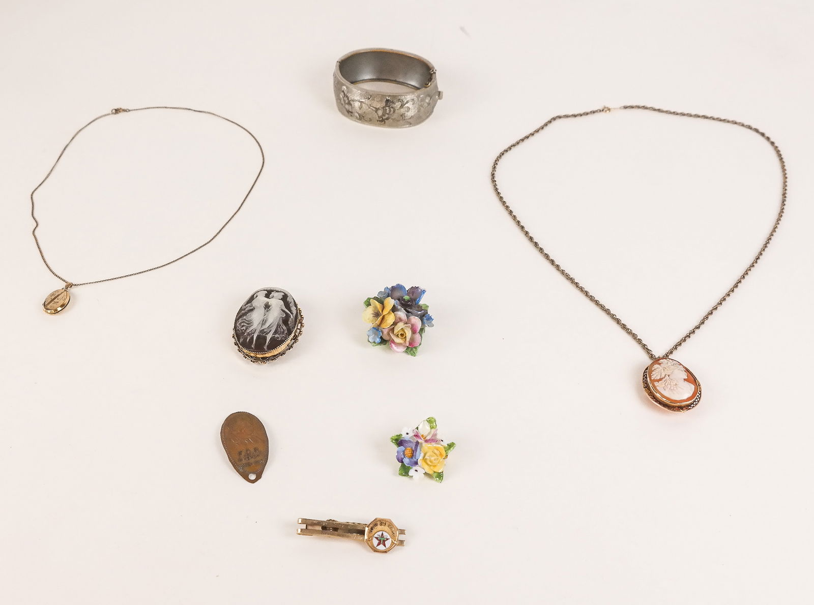 Assorted Costume Jewelry: Lot of assorted costume jewelry, including a bracelet, cameos on chains, Staffordshire brooches, and others.