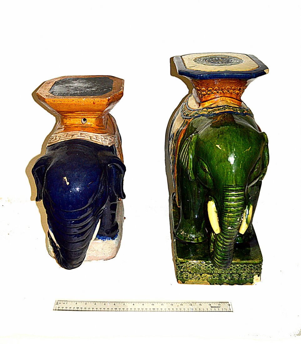 Two Asian Ceramic Elephant Garden Seats: Comprises: 1.) Green glaze elephant with multi-color seat. [10"W x 22"D x 23 1/4"H] 2.) Blue glaze elephant. [9 3/4"W x 23"D x 20"H] Both bear chips and losses, otherwise structurally sound.